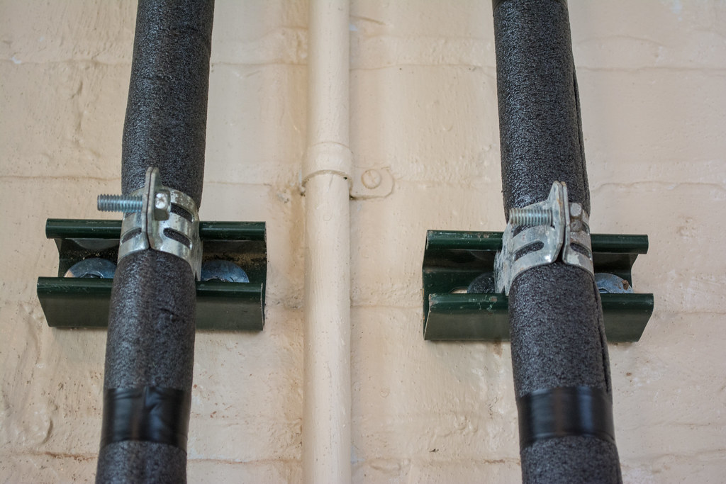 thermal wrapped water pipes tied to wall with brackets - 2015-03-13